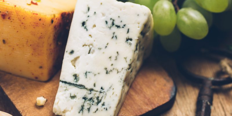 Blue cheese on wooden background